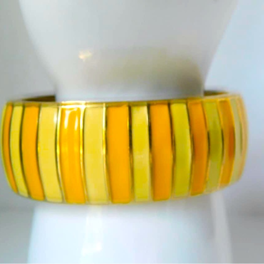 Gold tone metal with shades of Yellow Enamel Clamper Bracelet.Measures 2.5" x 2"